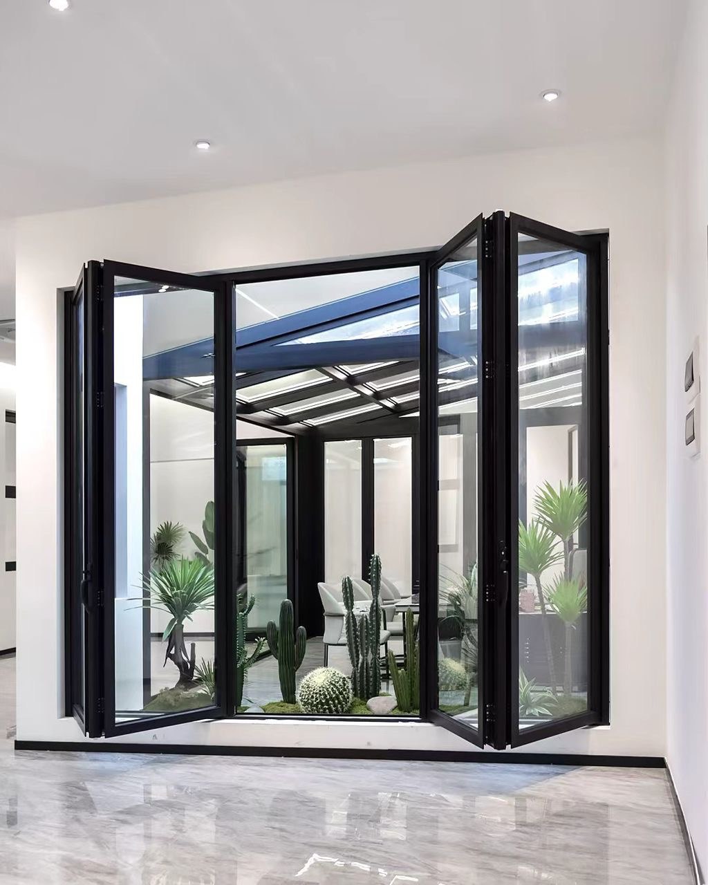 Black folding glass door system opening onto a bright conservatory